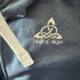 Close-up of the words Isle of Skye with a Celtic symbol on embroidered on a hoodie jacket with a zipper.